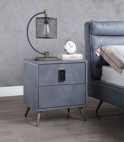 The Doris Nightstand by Acme Furniture features two drawers, splayed legs, a keyed security system, three electric outlets, two USB ports, and a grey finish.