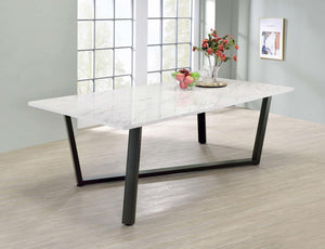  this dining table features a spacious faux marble top and an asymmetrical gunmetal metal base. The clean white surface offers the elegant look of marble with easy-care convenience
