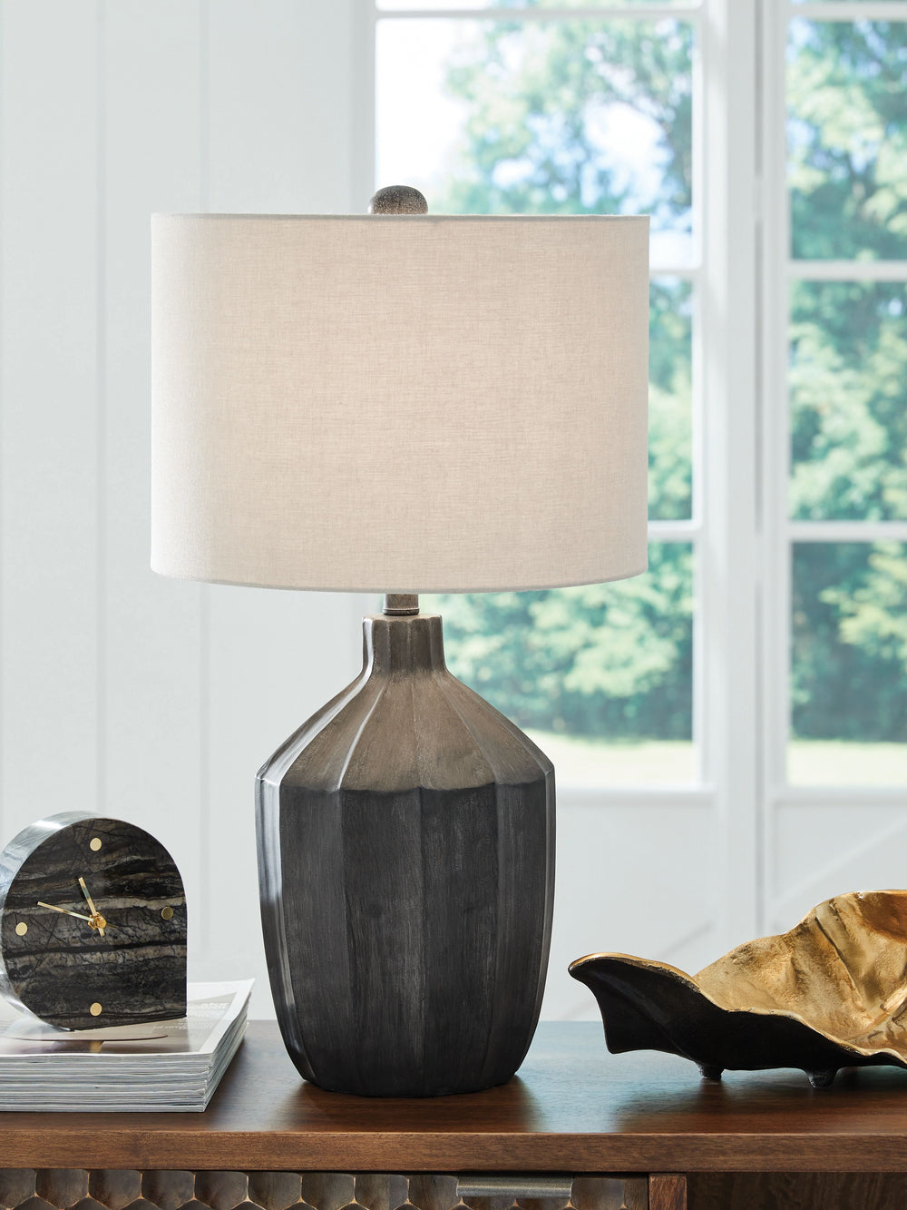 Looking for a unique take on casual style? Youâ€™re gonna love this table lamp. Its vertical line-patterned base, finished in chic black, is sculptural and spectacular without being fussy. Just brilliant.<br><br><b>Additional Dimensions</b><br><ul><li>Sha