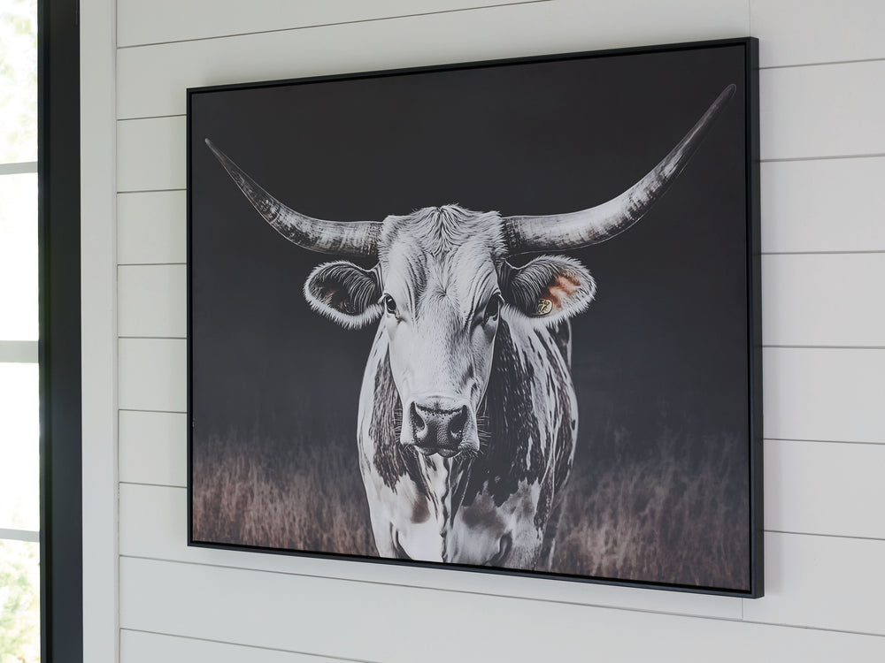 Add homespun charm to modern farmhouse and casual spaces. A longhorn cow takes center stage in this wall art, its white coat contrasting beautifully against the dark background tones. A sleek black frame completes the look.<br/><br/><b>Product Features</b