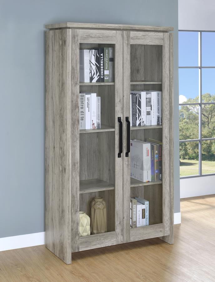 This tall curio cabinet makes for an impressive addition to a well-appointed home. The charming cabinet has classic sense of style and design. Two glass doors with contrasting dark hardware give the curio a distinguished appearance. The doors provide easy