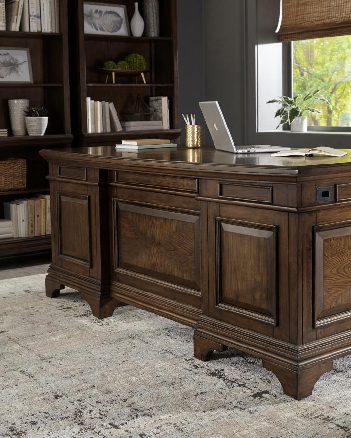 Feel like a CEO every day you sit down on this exquisite executive desk. Finished in burnished oak, it provides a traditional stylish flair to your office space. Two felt-lined top drawers allow you to store small items while you lock valuables inside the