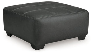 Appeal to your eye for ultra-contemporary design with this oversized accent ottoman. Chic and sleek in dark neutrals, it pairs cozy fabric with faux leather for invitingly cool character. And with its robust size offering extra legroom, you can chill out 