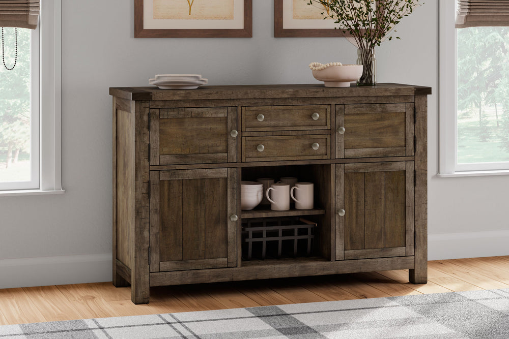 This dining room server might be simple at first sight, but a closer look reveals beauty in the details. With the plank-effect cabinet doors and table top, distressed nutmeg finish and antiqued bronze-tone hardware, itâ€™s simply beaming with charm. The s