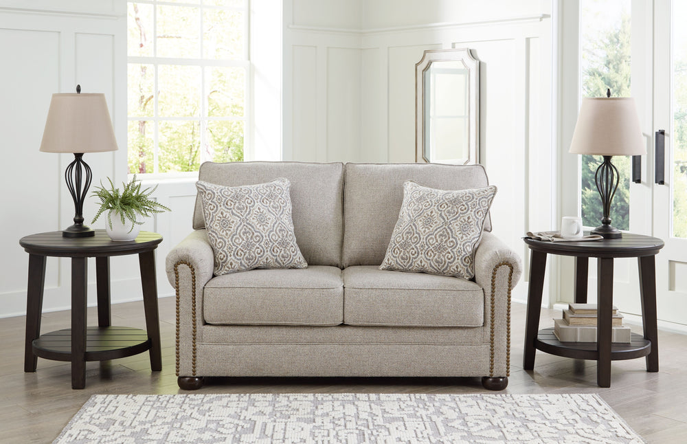 Inspired by the past but rooted firmly in the present, this loveseat complements your transitional seating area. Its versatile upholstery is delightfully detailed for a subtle herringbone effect. Designer touches like decorative nailhead trim and bun legs