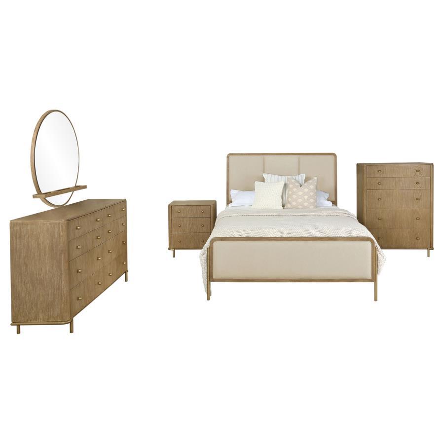 This coastal-inspired bedroom set blends mid-century modern influences with natural textures for a serene retreat. The bed features a cream fabric upholstered headboard and footboard, framed by a wire-brushed wood finish that enhances the beauty of rubber