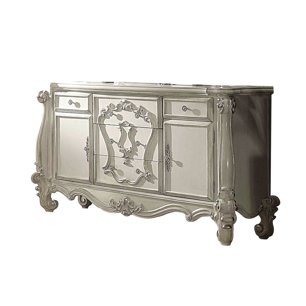 The Versailles dresser is the perfect accent to create the style of royalty your bedroom has been needing. This dresser crafted in wood with bone white finish was inspired by old European design with brown copper metal hardware and intricate wood carvings