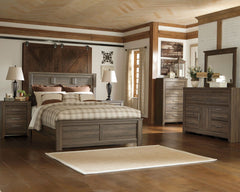 Vintage aged brown rough sawn finish over replicated oak grain. Large scaled rustic bedroom collection features case pilasters and thick poster bed posts. Substantial warm pewter color drawer handles. Poster bed offers optional footboard storage. Side rol