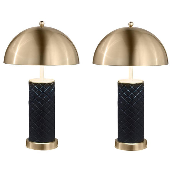 Bold and sculptural, this matching set of dome table lamps blends quilted texture with a sleek metallic finish. The rounded dome shades cast warm downward light, perfectly balanced atop cylindrical black bases wrapped in a quilted pattern for added depth.