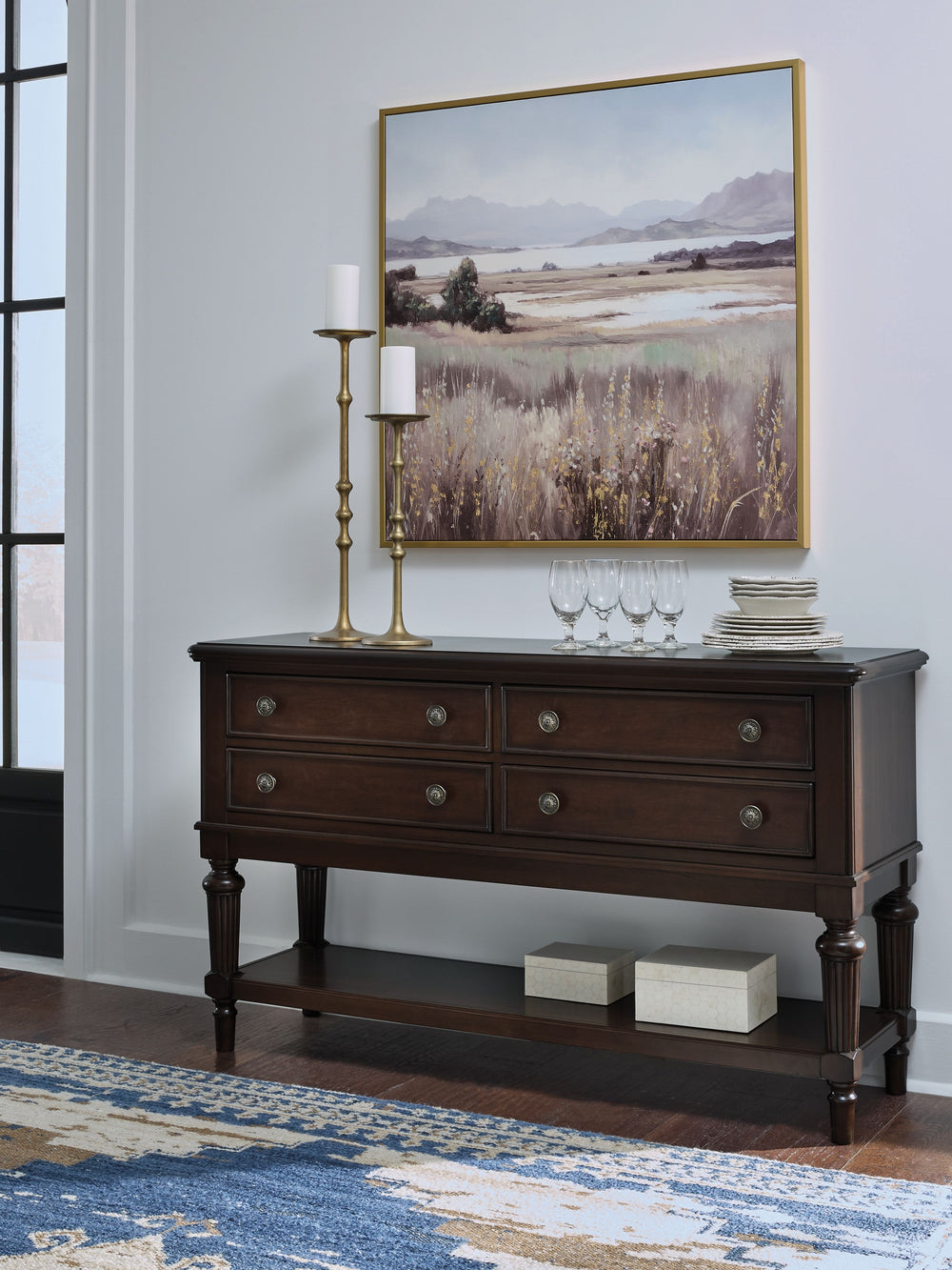 Serve up elegance and poise with this dining server. Its traditional silhouette is detailed with reeded legs for added opulence. Smooth-gliding drawers tuck away linens and other dining accessories when not in use. An open display shelf is the perfect hos