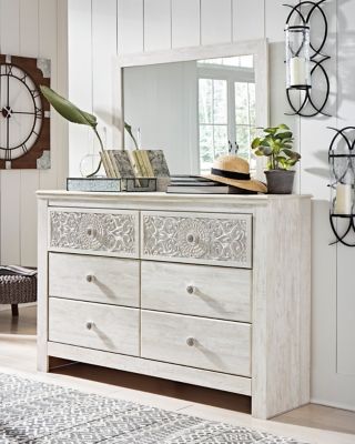  this whitewashed dresser and mirror set invites you to go to town. Its distinctive weatherworn finish conveys an easy-breezy sensibility: perfect for a restful bedroom retreat. Tastefully edited