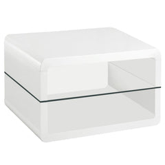 This ultra-modern square end table features a sleek white high-gloss finish and a clear tempered glass shelf for functional storage or display. Crafted from durable engineered wood, its rounded edges lend a contemporary touch while ensuring lasting qualit