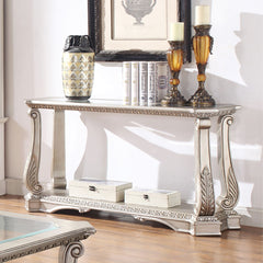 Entertain in style with the Northville Sofa Table. This classic rectangular occasional table features an Antique Silver and a tempered glass top. This distinctive cocktail is accented with wooden floral scrolled legs and a beveled glass insert and an open