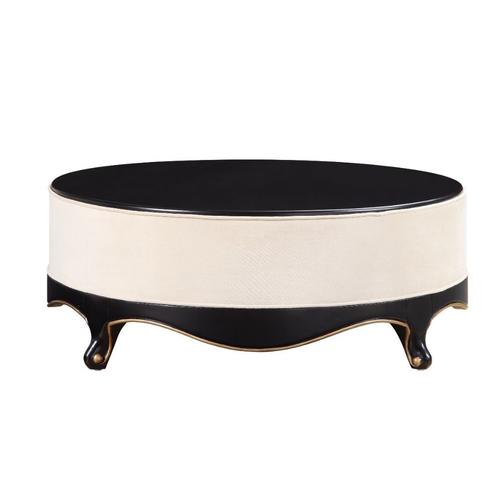 The Sheridan Cocktail Table is rich in detail and will make a statement in any living area. This classic round coffee table showcases a distinctive style for an intriguing look. Featuring a cream fabric upholstered frame with gorgeous scalloped apron and 