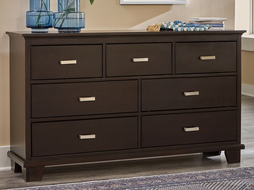Feast your eyes on this richly versatile dresser. Its traditional-inspired dark brown finish effortlessly blends with contemporary bright nickel-tone pulls to create a stunning look that-'s not too stuffy or too trendy. Spacious drawers offer plenty of st