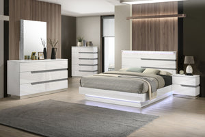 The Paradox 6 Piece Platform Bedroom Set is a marvel of contemporary design and elegance. With its gleaming white gloss laminate finish, this set not only boasts a sleek and modern look but also provides unparalleled scratch and water resistance. Expertly