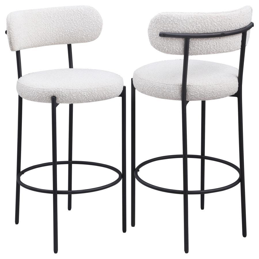 Refresh your kitchen island or elevated bar table with a set of two modern barstools. Each features foam cushions and contemporary boucle upholstery in a neutral hue. Black finish metal framing provides excellent support and durability, while slim legs an