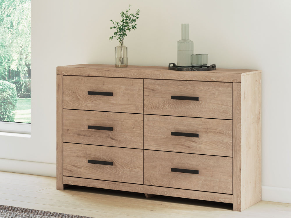 This dresser brings a touch of modern farmhouse charm to your home. Its light oak finish and clean lines have a fresh, airy feel, effortlessly creating an inviting atmosphere for a restful nightâ€™s sleep. Six spacious drawers with large black handles pro