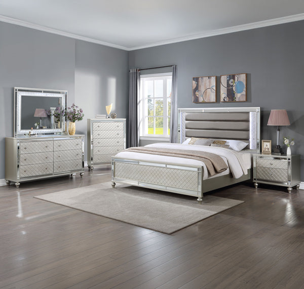 Elevate your sanctuary with this dazzling bedroom collection, where contemporary chic meets timeless charm. The suite boasts a stunning silver finish, imbuing your space with an air of sophistication and modern luxury. At the heart lies a plush, channel t