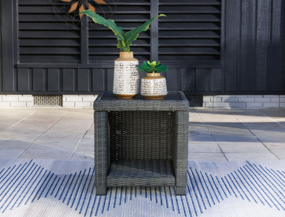 Add a distinguished touch of gray to your outdoor living space with this end table. This head-turning table is made with resin wicker over an aluminum frame for a relaxed look that provides seasons of enjoyment. Its aluminum top combines the exceptional d