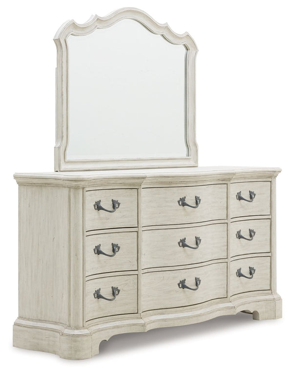 Add a touch of romance to your bedroom with this dresser and mirror. Its antiqued white painted finish and serpentine-shaped silhouette are the definition of easy elegance. Custom-designed aged pewter-tone hardware adds surprisingly casual appeal.<br/><br
