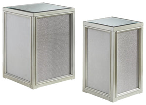 Reminiscent of Hollywood glamour of yesteryear, this set of nesting end tables interprets luxury in a decidedly modern way. A dazzling metallic silvertone finish and textured laminate panels for added luster enhance the star power, while the beveled inset