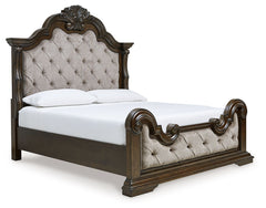 From its ornamental appliques to its large scale, this king upholstered bed makes a bold statement. Showcasing sculptural ornate details and button tufting, this opulent bed wows with stunning style. The look is timeless. The feel? Right at home.<br/><br/
