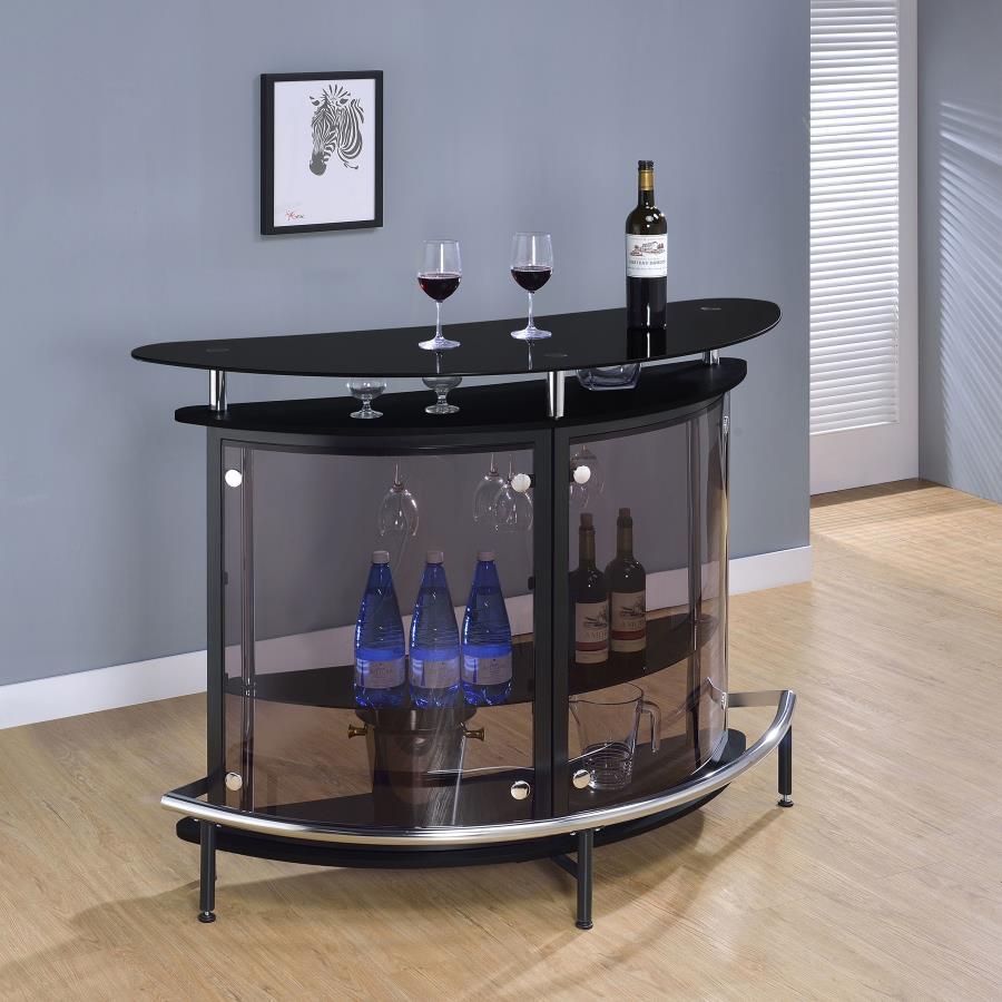 Beautifully crafted with high-quality acrylic panels and a clear glass top, this contemporary bar unit lets you entertain in style. Its smooth, curved silhouette gives it an elegant appearance. With a spacious storage area, it leaves plenty of room for al