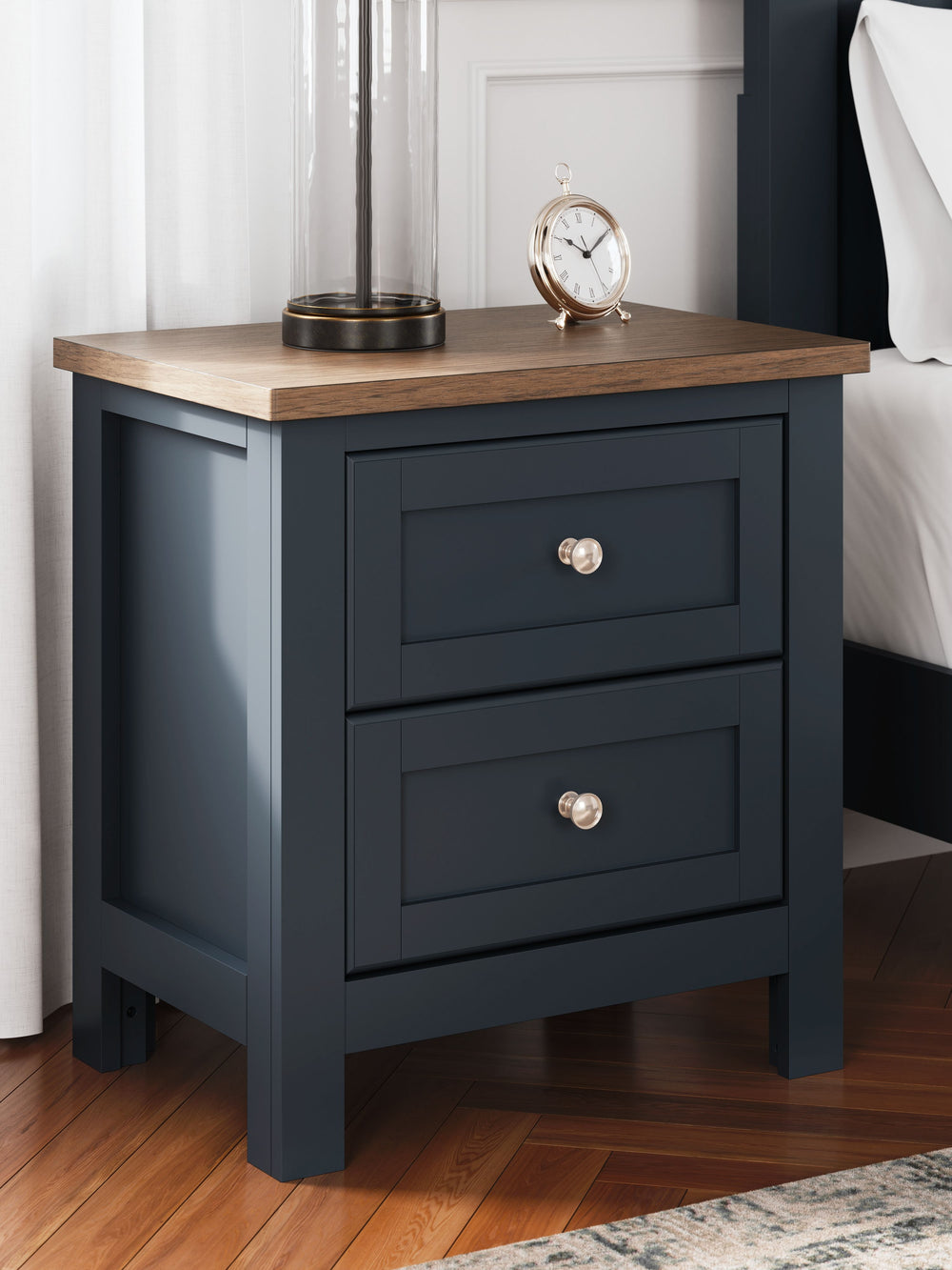 Add homespun charm to your restful retreat. A modern take on a timeless silhouette, this nightstand pairs a dark slate blue finish with a light brown top. Drawer fronts and legs in a classic Shaker style bring an air of beautiful simplicity to the bedroom