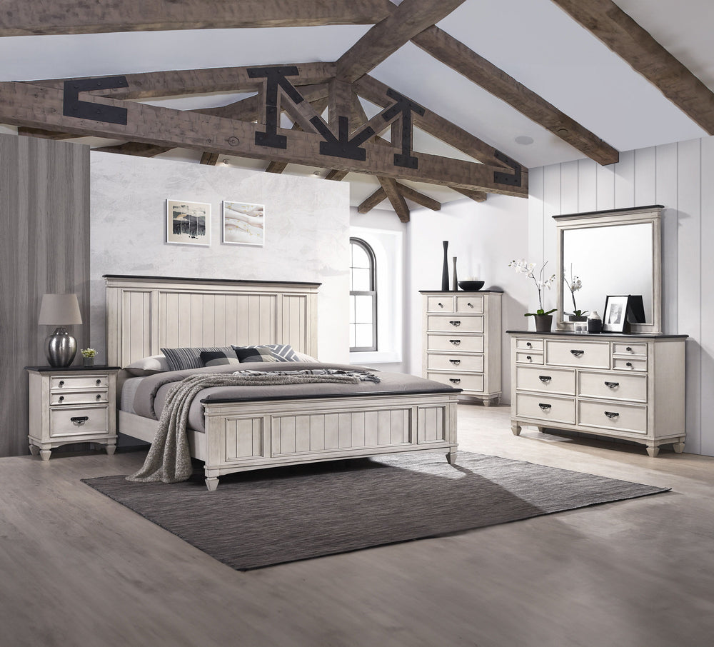 This exquisite bedroom collection epitomizes timeless elegance, with its classic silhouettes and refined antique finish. The bed, distinguished by its beautifully paneled headboard, anchors the space with its traditional charm. An integrated footboard ben