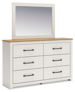 Create a serene countryside retreat with this dresser and mirror set. The two-tone design effortlessly adds farmhouse style, while framed drawer fronts with pewter-tone handles enhance its charming appeal. Looking for furniture that offers storage and a p