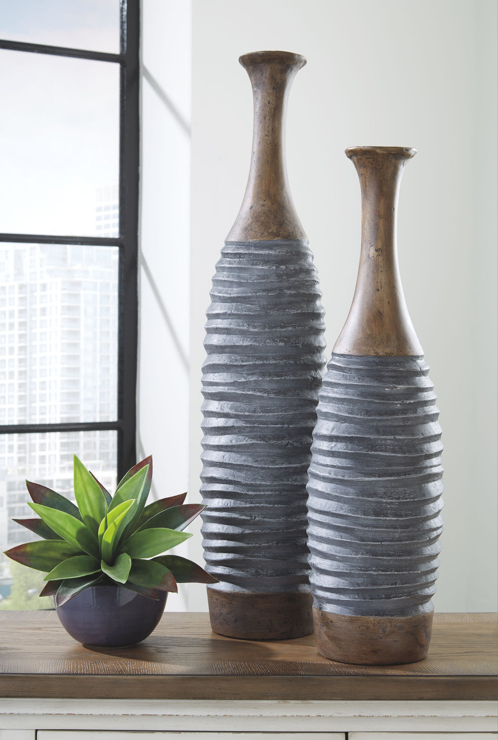 Add texture and interest to your space with this set of two vases. Made of a composite paper material, these sculptural objects make it easy to cut and paste design brilliance into your home decor.<br><br><b>Additional Dimensions</b><br><ul><li>Vase-large