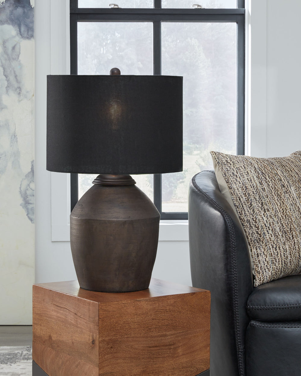 Add a touch of casual elegance to your home with this table lamp. Its stunning metallic black finish over terra cotta offers a striking effect. This lamp exudes an informal yet stylish aesthetic, creating the ideal lighting accent for casual spaces. Just 
