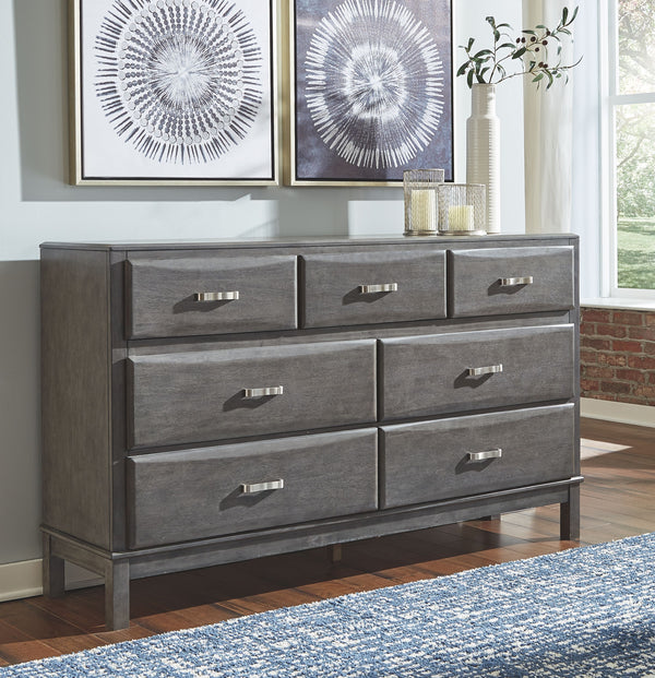  the dresserâ€™s contoured drawers offer ample storage options. Sporting a distinctive weathered gray 