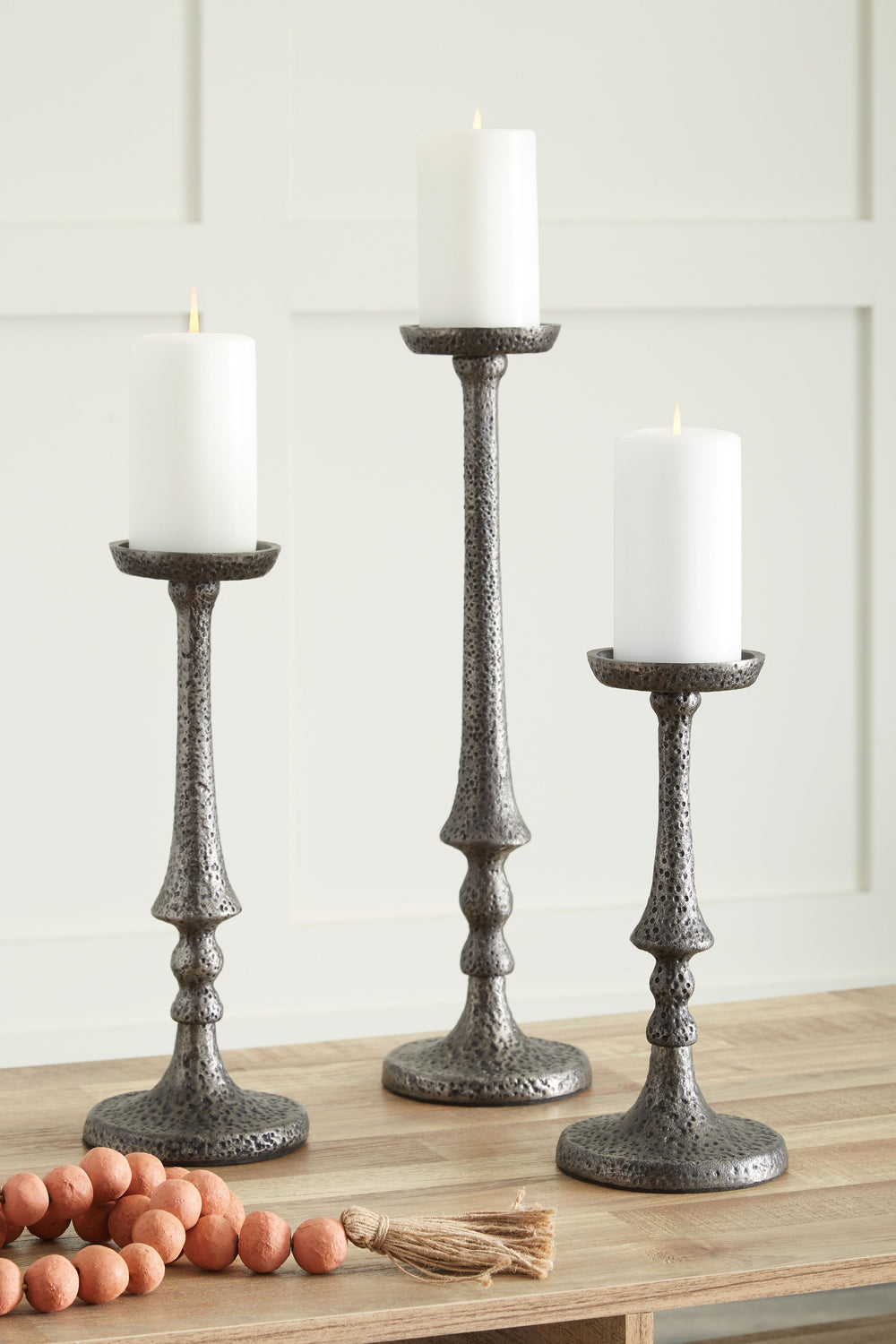 Is your ideal air of ambiance filled with antiqued flair? We invite you to tap into the plentiful possibilities of these candle holders. Scatter the set across shelves in your in-home library or office as a moody backdrop for your next illuminating idea. 