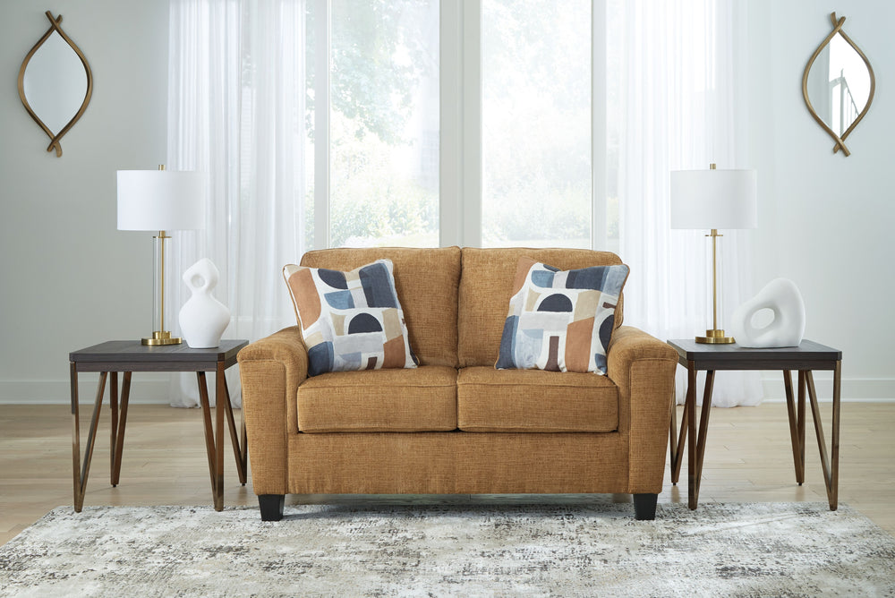 Thereâ€™s something about this loveseat thatâ€™s so easy to appreciate. Maybe itâ€™s the plush upholstery and comforting earthy tone, eager to support your quest for total relaxation. Perhaps it-'s the modern flair of its simple lines, tapered legs and ab