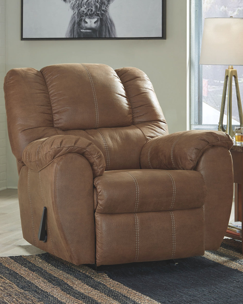 Rock the cool look of leather and the warm feel of fabric with this rocker recliner. Sporting sumptuously thick cushioning, fashion-forward jumbo stitching and a richly tailored aesthetic, this smartly priced recliner with gentle rocking motion is a bests