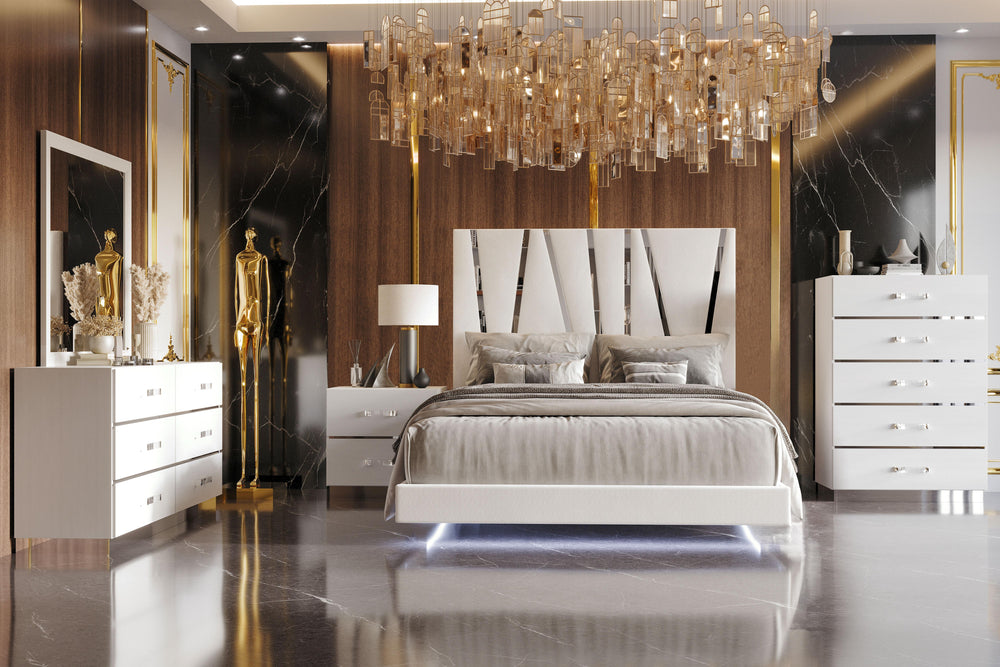 The Europa 5 Piece Bedroom Set in white brings modern elegance and practical functionality to your bedroom. This set includes a panel bed as well as a dresser, mirror, nightstand, and chest. The sleek design features a majestic headboard, glossy white fin