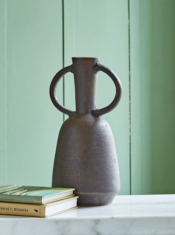  this decorative vase brings well-crafted character to your home. Its distressed neutral tone makes it a go-to all year as you swap out faux florals and filler with the seasons. Large handles complete this strik