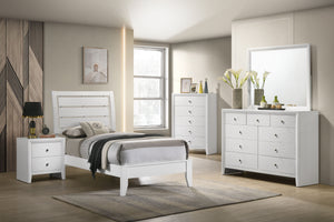 This inviting bedroom set features a refreshing white finish with subtle textural details that add a touch of modernity. The clean-lined bed boasts a distinctive headboard with horizontal slats that create an airy, open feel, promoting relaxation. Complem