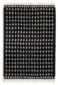 Sink your feet into this modern area rug. Offering a luxurious shag with woven dot design in black and white, this rug adds sophistication to any space without sacrificing comfort or durability. Finished with a braided tassel edge completing the design, t
