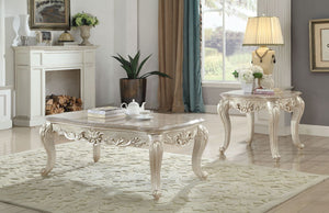 Elaborate old world designs are treated with a distinctly modern touch on the Gorsedd coffee table. This elegant wood table features a stunning scalloped marble table top and detailed table legs in a rich antique white finish. This unique rectangular tabl