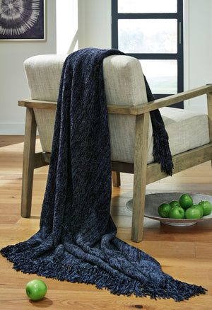  this dark blue throw also makes a stylish statement. Whether the blanket is draped over the arm of a sofa or folded at the foot of a bed