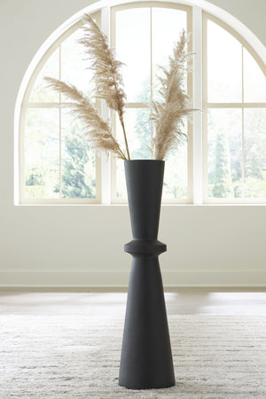  this black-hued vase is a versatile addition to your decor. Its hourglass shape and textured pattern make for an eye-catching standalone piece. Chic in an office corner or greeting guests in the entryway