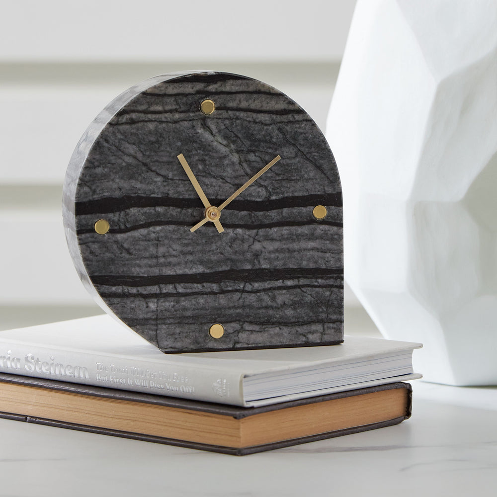 This table clock is a contemporary take on classic function. Crafted with black marble, it brings an elevated feel to tabletops and decorative displays. Staying on time has never been so stylish.<br/><br/><b>Product Features</b><ul><li>Made with black mar