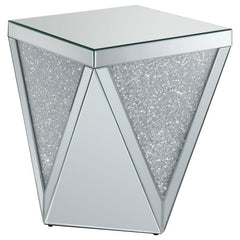Dress up your decor with breathtaking, modern luxury. This mirrored end table combines a bold, diamond-shaped design with triangular panels of eye-catching, glittery material. The triangular mirrored surfaces create reflective beauty, while sparkling acry