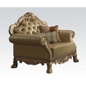 The Dresden gold patina and bone faux leather chair has a traditional feel, featuring decorative carvings, inlay veneer ball and claw feet and hand brushed gold accents. The seat and back have a faux leather button tufted cushion with Nailhead trim. Comes