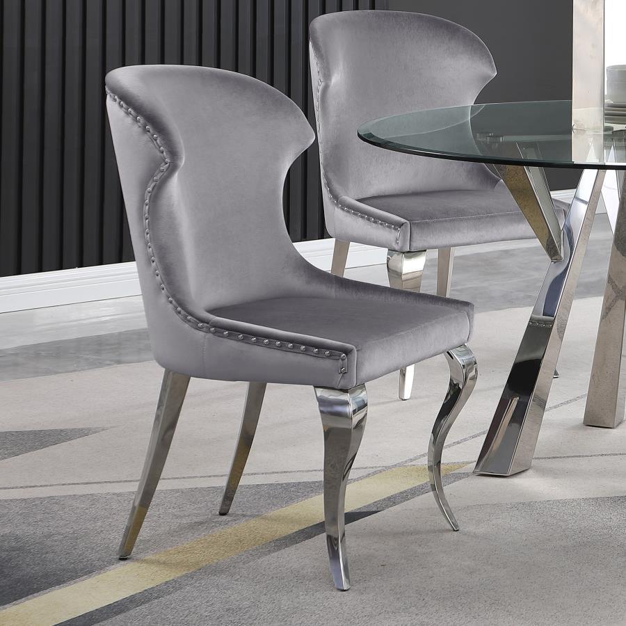 Indulge in the ultimate dining experience with the demi wing dining side chair. Its polished stainless steel cabriole legs exude sophistication, while the individually hand-driven nailhead trim adds a luxurious touch. Wrapped in soft velvet upholstery, th