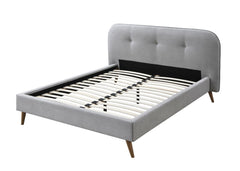 Unexpected gray tone paired with natural wood accents creates a relaxing sleep environment for you. The fully upholstered bed features a button-tufted headboard for a comfortable spot to lean on. Gray fabric upholstery fills the bed with a stunning textur