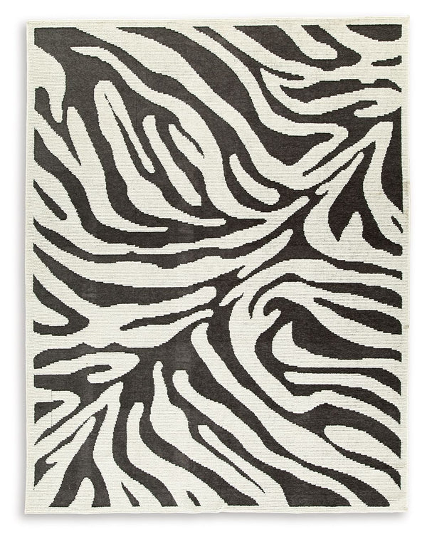 Cover your floor in safari vibes. A bold zebra design on this area rug brings a bit of rugged chic to any room. Machine washable for easy maintenance, the contemporary statement piece knows no boundaries.<br/><br/><b>Product Features</b><ul><li>Made of po